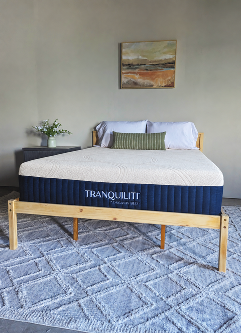 Tranquiliti mattress by Organix Bed on a wooden platform bed in a bedroom